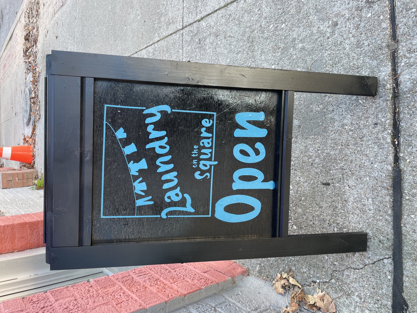 The Laundry on the Square sidewalk sign